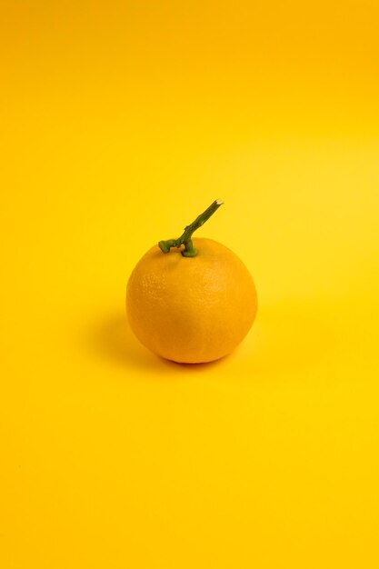Close-up of orange fruit against yellow background