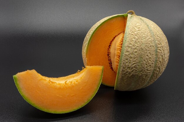 close-up of orange fruit on table against black background