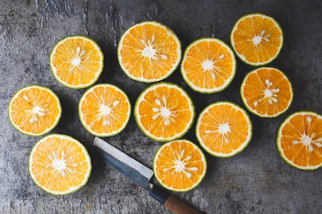 Close-up of orange fruits and knife on table