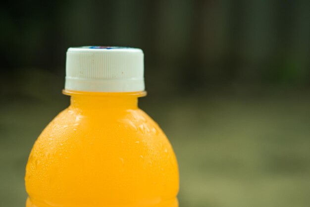 Close-up of orange juice in bottle