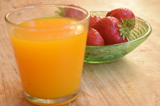 Close-up of orange juice in glass on table