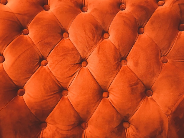 Close-up orange leather sofa backrest background