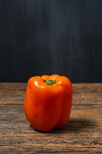 Close up Orange Peppers on wooden table with copyspace whitespace for text Healthy food concept