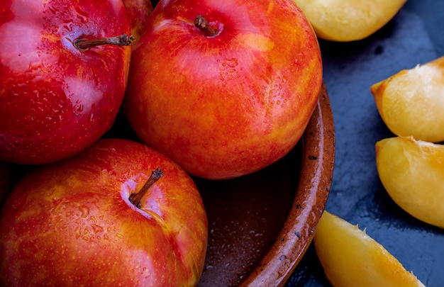 Close-up of orange plums in a bowl