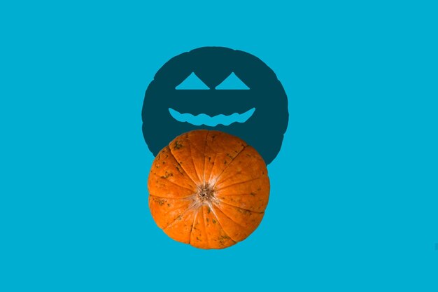 Photo close-up of orange pumpkin against blue background