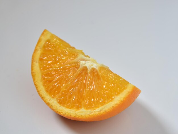 Close-up of orange slice against white background