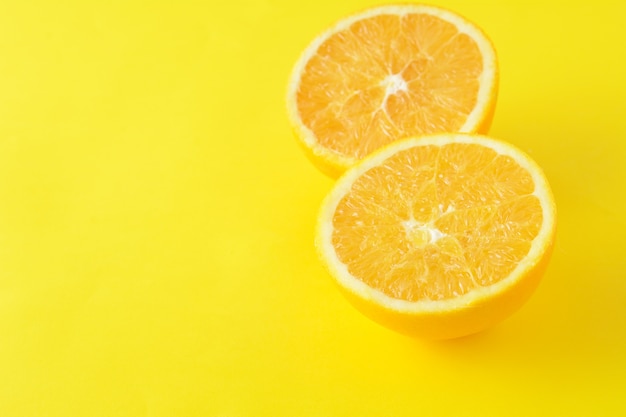 Close up of orange slices on yellow background