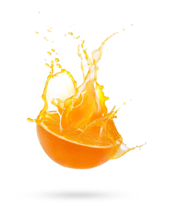 Photo close-up of orange splashing against white background