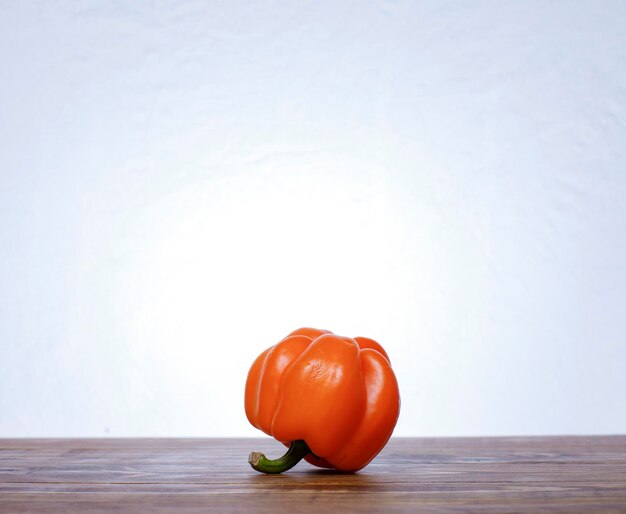close-up of orange on table against white background