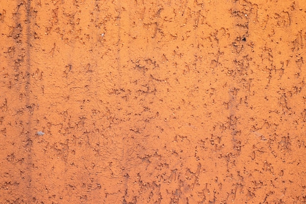 Close up of an orange textured wall.