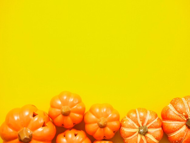 Close-up of oranges against yellow background