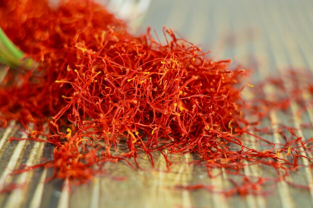 Close up of oriental saffron dried spice on wooden spoon.