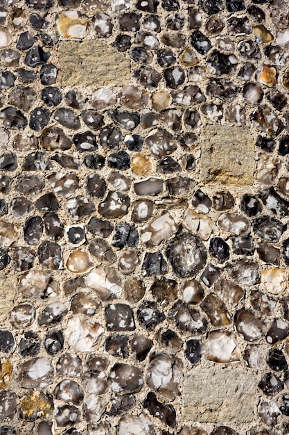 Close up of the outer wall of an English medieval castle made of flint