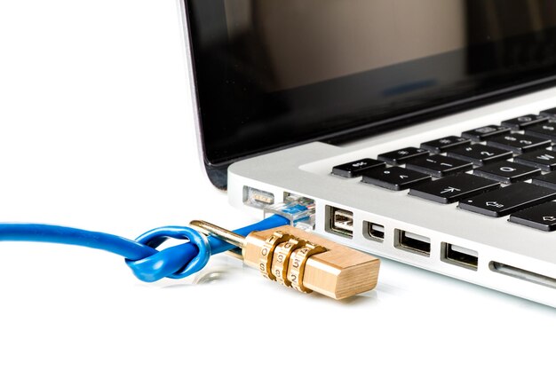 Photo close-up of padlock and cable on computer keyboard against white background