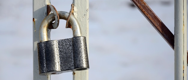 Close-up of padlock on metal railing