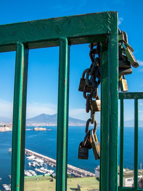 Close-up of padlocks on railing against sea