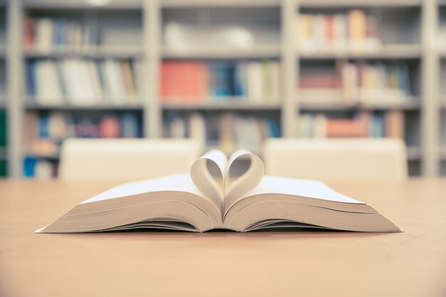 Close up page of a book in heart shape.