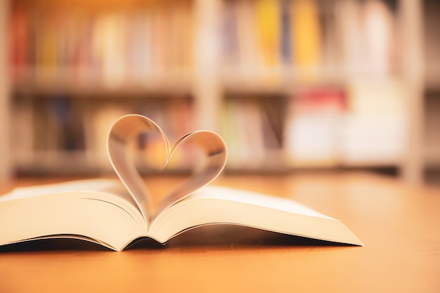 Close up page of a book in heart shape.