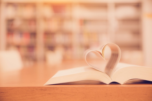 Close up page of a book in heart shape.