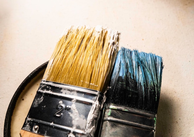 Close up of paint brush on textured wall