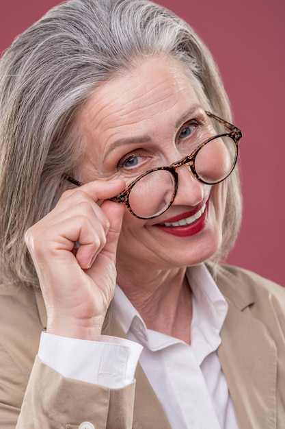 Close up of a pampered mature woman in eyeglasses