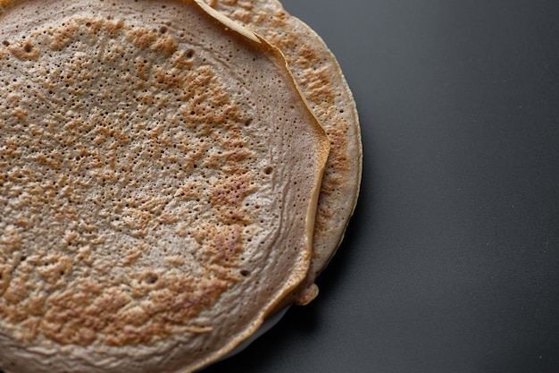 A close up of a pancake with a brown crust.