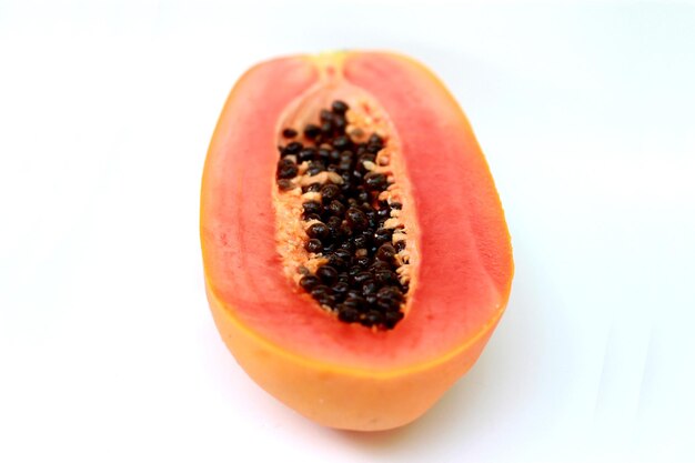 Close-up of papaya on white background