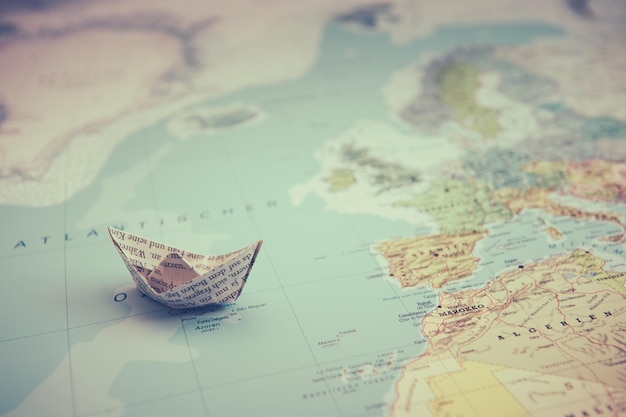 Close-up of paper boat on map