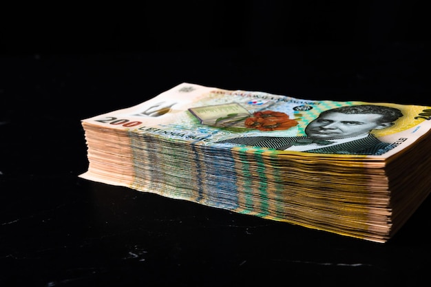 Close-up of paper currencies on black background