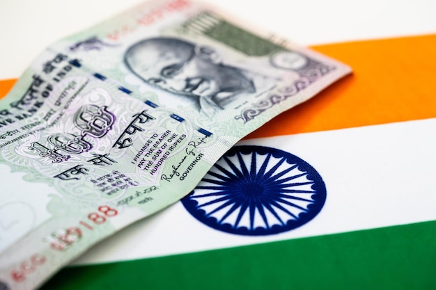 Close-up of paper currency over indian flag