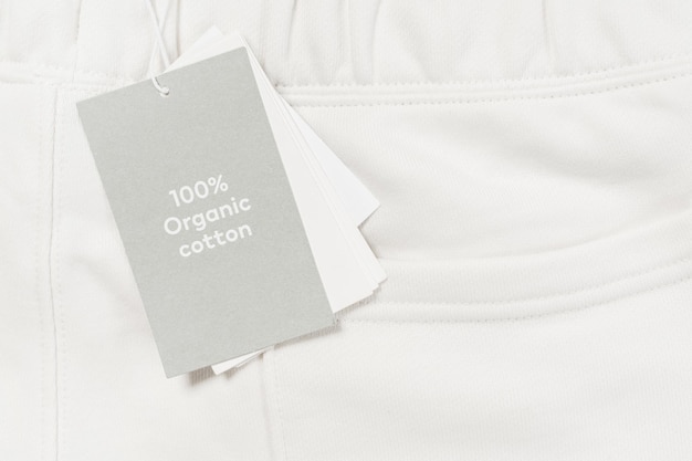 Close-up of paper label on a white 100% organic cotton clothing