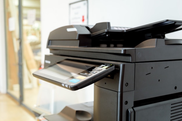 Close up paper sheets on the printer in office room.