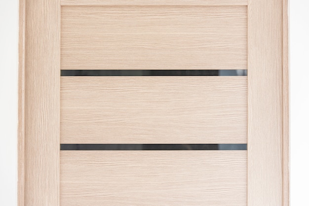 Close-up part of modern wooden door in living room, interior