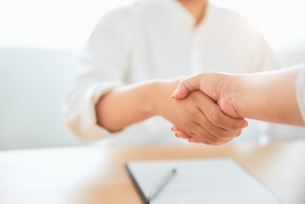 Photo close up of partnership handshake successful after negotiating business