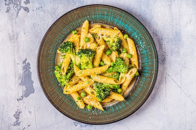 Close up on pasta with broccoli and green peas