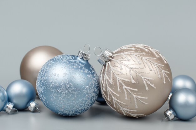 Close up pastel Christmas baubles on grey