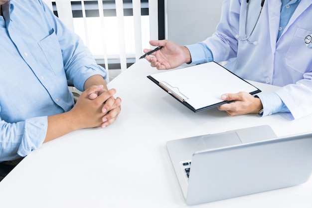 close up of patient and consultant doctor give an advice in a hospital or clinic