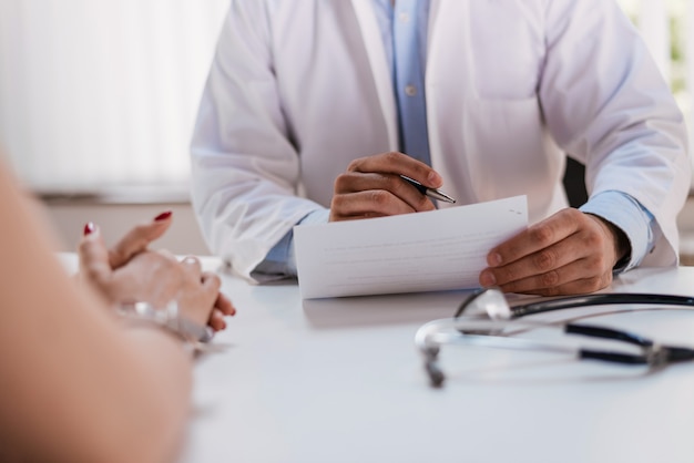 Close up of patient and doctor taking notes