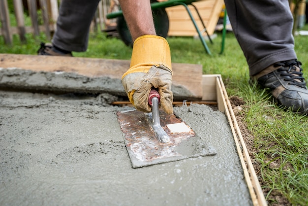 Close up on paver smoothing fresh concrete