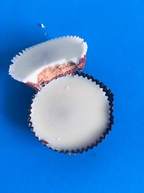 Photo close-up of peanut butter cups against blue background