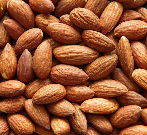 close up Peeled almonds nut background