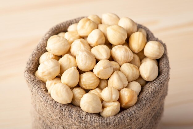 Close up of peeled hazelnuts in linen sack