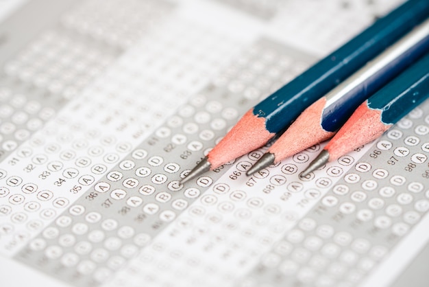 Photo close up pencil on the answer sheet for test score sheet with answers