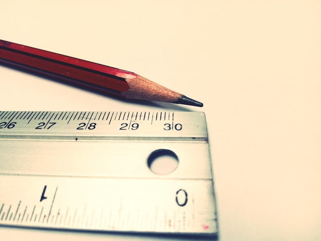 Close-up of pencil by ruler on table