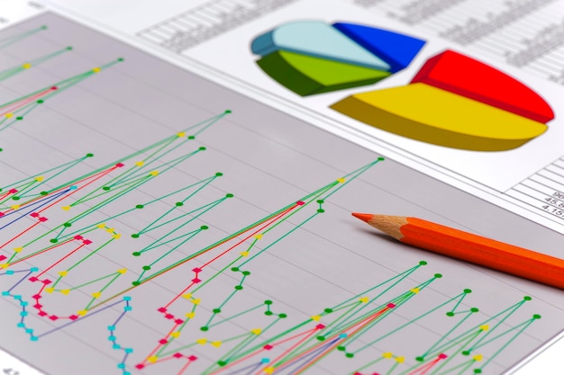 Photo close-up of pencil on colorful graph chart