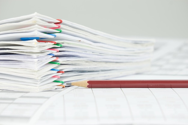 close-up of pencil with files on financial documents