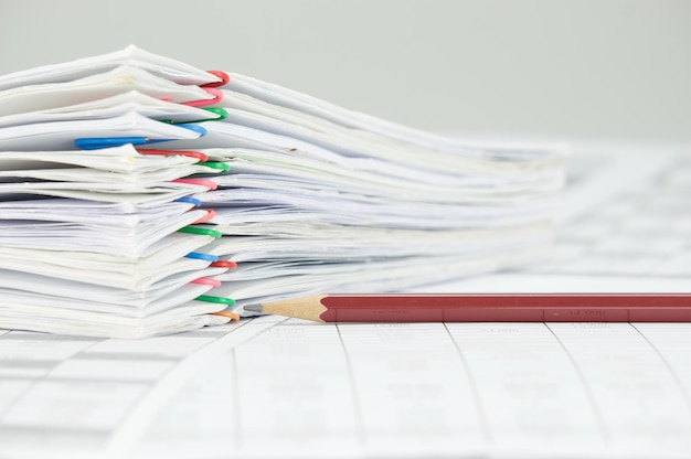 Photo close-up of pencil with files on financial documents