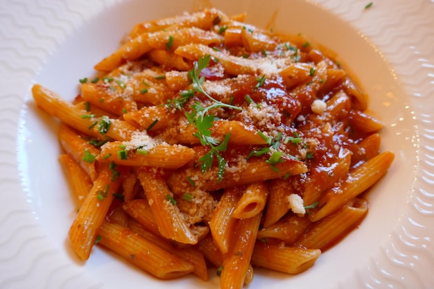 Close-up of penne cheese pasta in tomato sauce