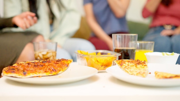 Photo close up of people eating delivered pizza