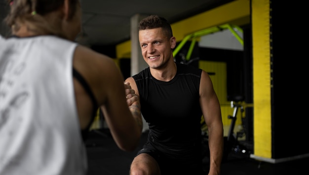 Close up people holding hands at gym